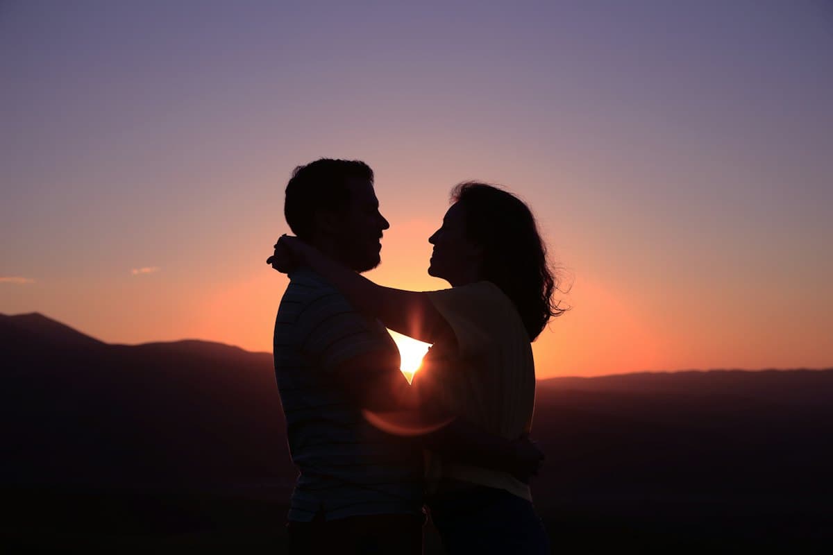 Silhouette of a couple embracing at sunset